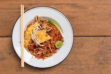 Traditional Thai fried noodle on wooden texture and background