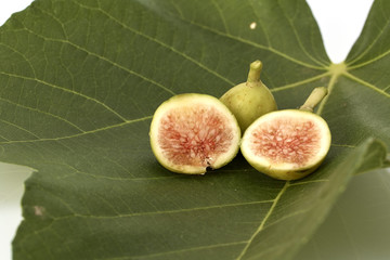Fresh green figs on white background