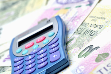 Close-up of blue calculator on czech crowns CZK - concept of financial background