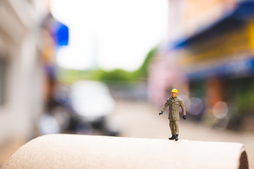 Miniature people, engineer standing action using as business and industrial concept