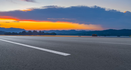 Asphalt road square and river hill under the blue sky