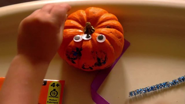 Video Of A Young Toddler Boy Making Spooky Halloween Crafts With His Mom At Their Living Room Table