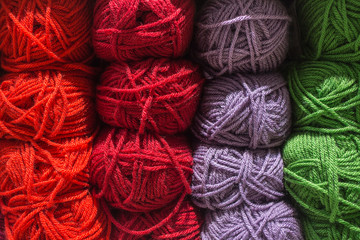 Roll of wool. Many color yarn and wool in skeins and yarns. balls of knitted wool on table.