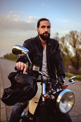 Fototapeta na wymiar Macho man sitting on his motorcycle