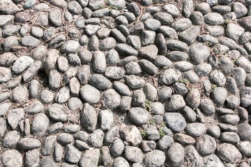 Texture of beige and gray stones on the ground. Grunge background.