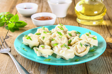 Homemade ready dumplings on an old wooden table.
