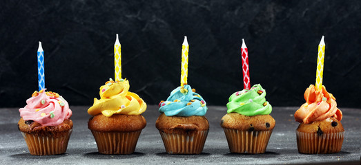 Tasty cupcakes on table. Birthday cupcake in rainbow colors.