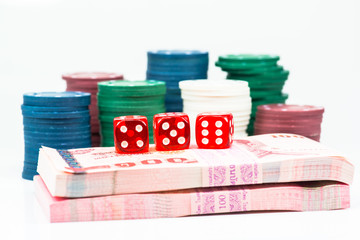Red dice with banknotes as background.