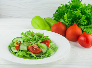 light summer salad of tomatoes, cucumbers and lettuce leaves