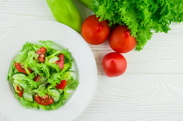 salad from tomatoes, cucumbers and lettuce leaves