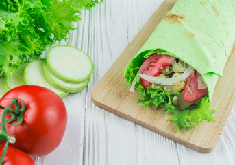vegetarian food - zucchini, tomatoes and lettuce leaves in pita bread
