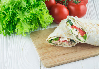 chicken shaurma in a cut, on a wooden background