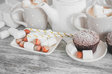 Fototapeta na wymiar Teapot, cupcakes and different decorations