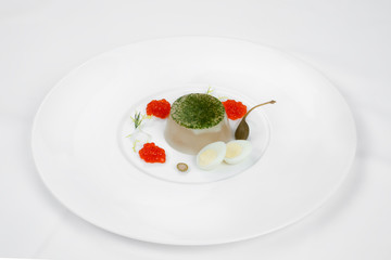 A beautiful dish from jellied fish with red caviar, egg and olive.