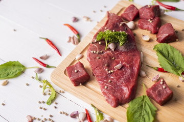 Raw beef on white wood background
