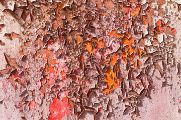 Old cracked paint on the concrete wall. Texture, pattern, background. The wall cracked with paint, abstract paint behind the iron. With a pink color, the paint eventually peels off