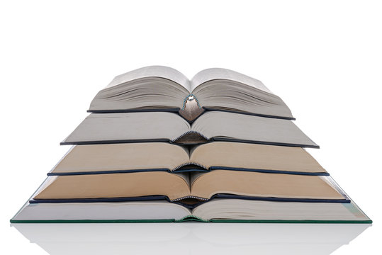 Open hardback books stack isolated on white