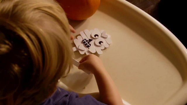 Video Of A Young Toddler Boy Making Spooky Halloween Crafts With His Mom At Their Living Room Table