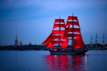 Ship with scarlet sails in the Neva river with city view background