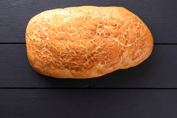 White bread on dark boards, fresh pastry from above, wheat bread from a wood-burning stove in retro style, blank for labels, French cuisine, copy space, art