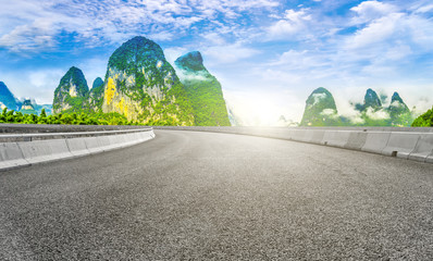 The empty asphalt road square and natural landscape under the blue sky