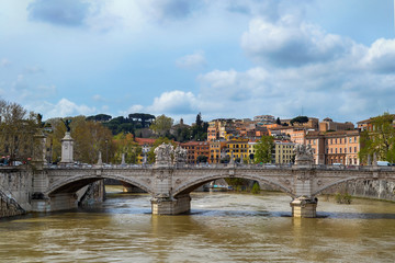 Fototapeta na wymiar Tiber river with ancient city architecture of Rome and beautiful old stone bridge, Rome, Italy.