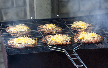 Meet with cheese on grill. B-B-Q