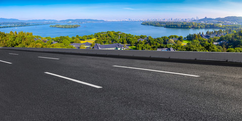 Asphalt road square and river hill under the blue sky