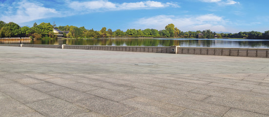 Asphalt road square and river hill under the blue sky