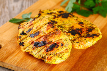 healthy food - grilled chicken with vegetables on a wooden board.