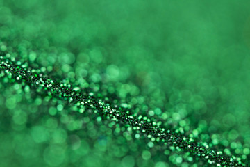 Green glitter texture close up macro. Abstract sparkle background.
