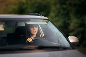 Stressed Woman Checking her Smartphone While Driving