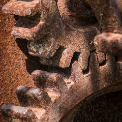 Closeup of two old rusty meshing gears