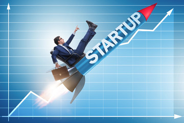 Businessman in start-up concept flying on rocket