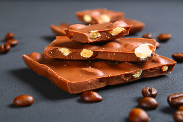 Coffee beans with chocolate on gray background.