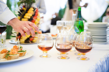 Delicious snacks on wedding reception table in luxury outdoor restaurant