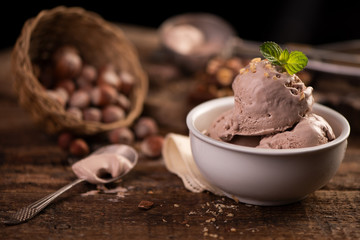 Fresh hazelnut ice cream on wooden table.