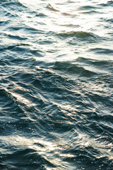 Surface of the sea with small waves of turquoise color.