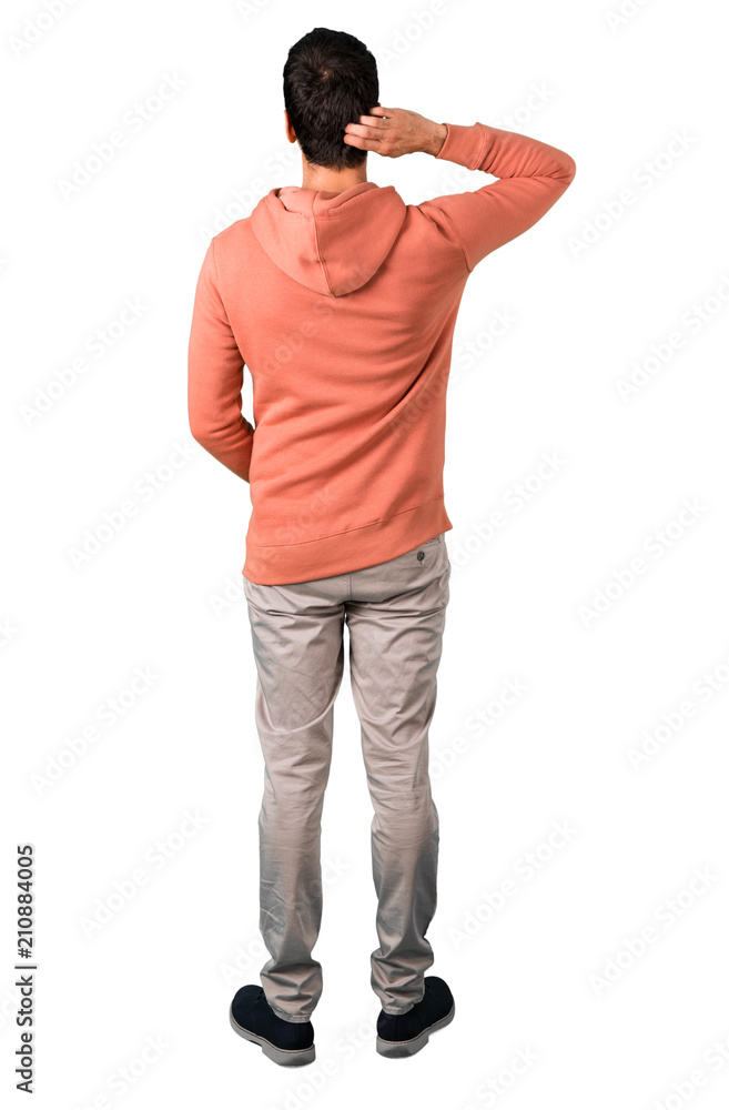 Wall mural full body of man in a pink sweatshirt looking back on isolated white background. ideal for use in ar