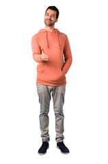 Fototapeta premium Full body of Man in a pink sweatshirt shaking hands for closing a good deal on isolated white background