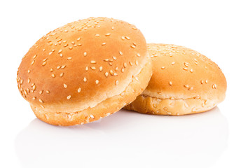 Two hamburger buns with sesame isolated on white background