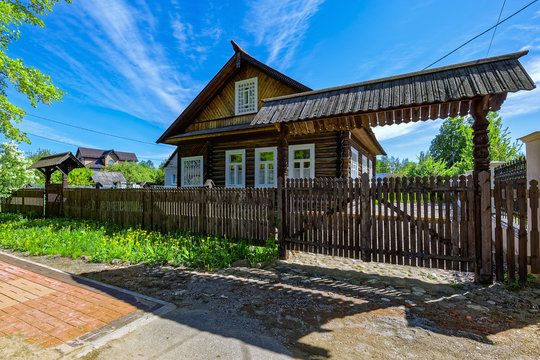 Traditional Russian old country wooden house with fence.