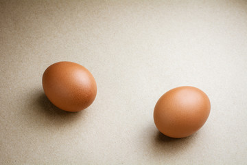 Brown chicken eggs on recycled craft paper