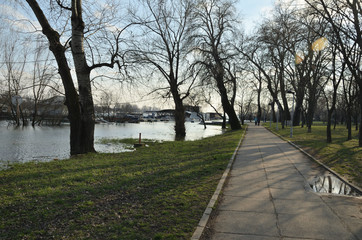 Promenade along a river bank flooded in a city area