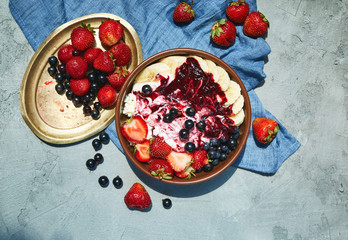 bowl of cottage cheese with berries, bananas and sour cream