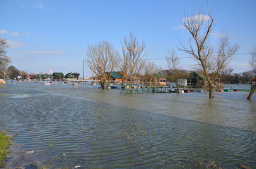 Flooded promenade along a river bank in a city area