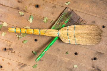 Green scoop with yellow broom for cleaning in the sauna