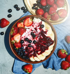 bowl of cottage cheese with berries, bananas and sour cream