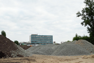 Industrial background with pile of gravel. Extraction of gravel. Construction of roads. Piles of...