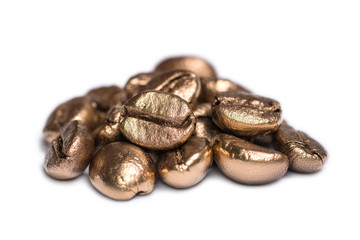 A pile of golden coffee beans is isolated on a white background
